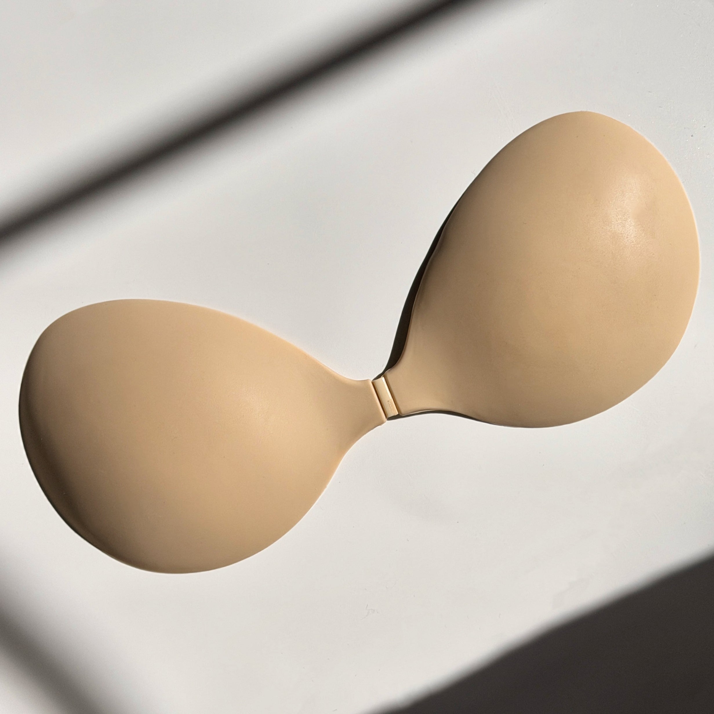 Flaty beige adhesive bra cups flat lay small bust AA A B cup